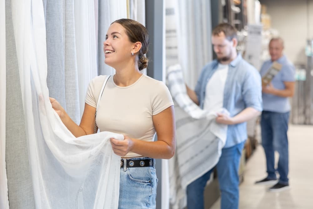 Woman examining drapery fabrics
