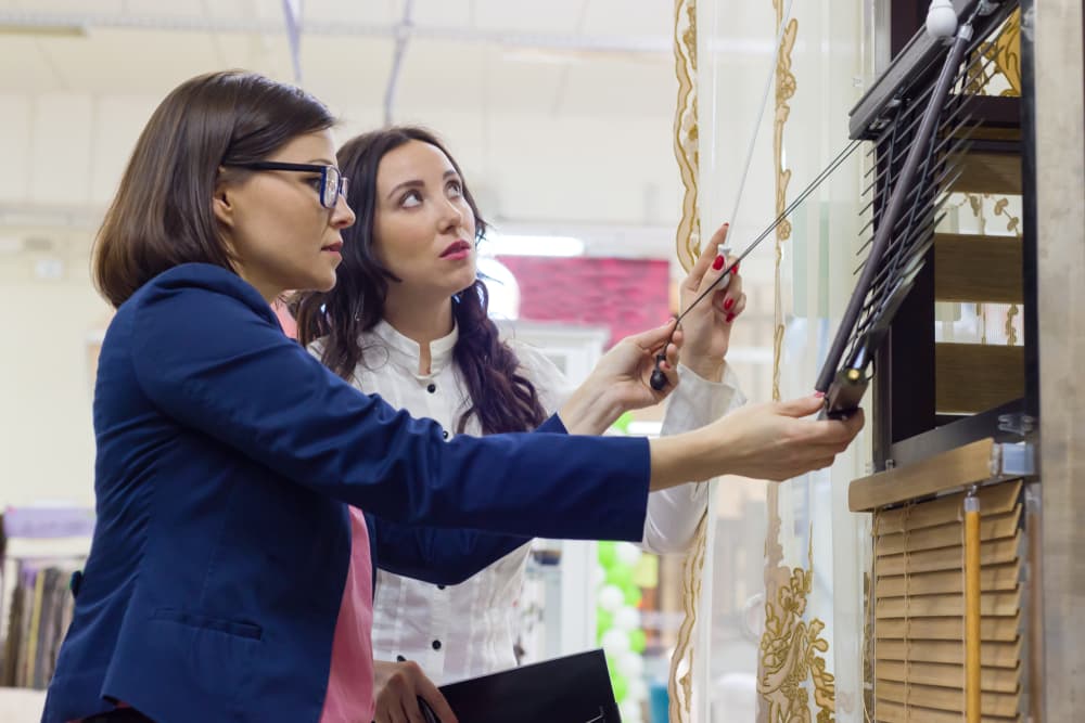 Women in the store choose blinds for windows
